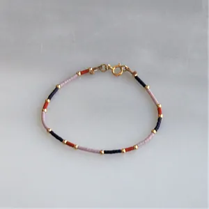 Bohemian colorful handmade beaded bracelet with navy blue pink beads and gold accents