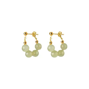 Elegant gold earrings with light green natural stone beads on a clean white background
