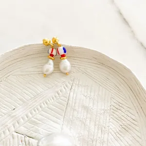 Close-up of 18K gold-plated hoop earrings with baroque pearls and colorful beads