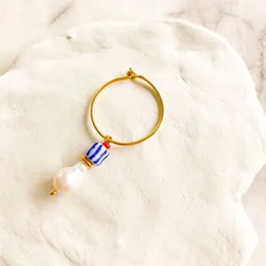 Detail of 18K gold hoop earring with baroque pearl and bohemian beaded charms