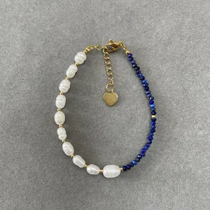Detail of vintage freshwater pearl bracelet with blue gemstones and heart pendant