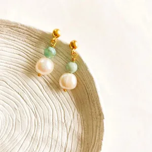 Detail of 18K gold-plated earrings featuring green beads and white freshwater pearls