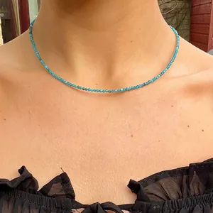 Delicate minimalist blue natural stone beaded choker necklace worn by a model