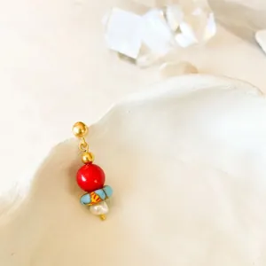 Macro shot of 18K gold plated hoop earring with colorful beads and pearl detail