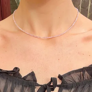 Close-up of minimalist thin purple beaded necklace on female model with black lace