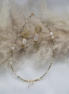 Detail of bohemian necklace and earrings with baroque pearls and colorful beads