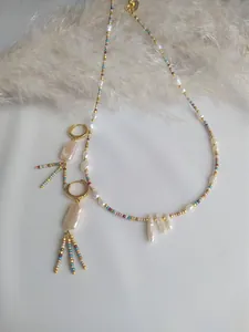 Detail of bohemian necklace and earrings with baroque pearls and colorful seed beads