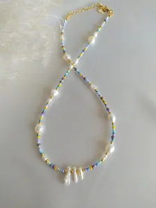 Detail of colorful beads and baroque freshwater pearls on a bohemian choker necklace