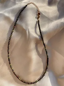 Detail of colorful faceted natural stone beads and 18k gold-plated lobster clasp with chain