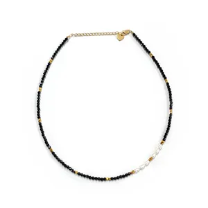 Minimalist black spinel choker with freshwater pearls and a gold heart charm