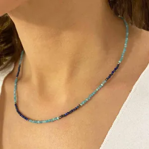 Faceted blue natural stone beaded necklace worn by a model in a minimalist style