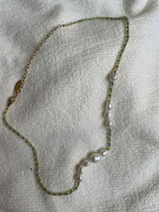 Detail of colorful beads and white freshwater pearls on a handmade boho necklace