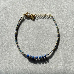 Lapis lazuli beaded bracelet with gold heart pendant and bohemian vintage charm