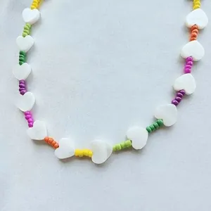 Handmade colorful seed bead necklace with shell heart pendant and vibrant rainbow pearls