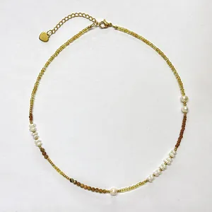 Freshwater pearl necklace with yellow and brown seed beads and heart pendant