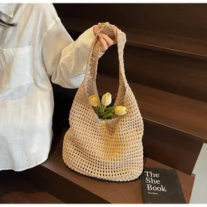 Close-up of beige crochet tote bag showing hollow weave texture and tulip decor