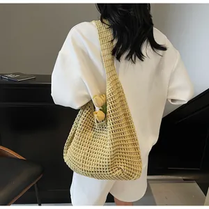 Detail of hollow-out woven texture on yellow tote bag with tulip decoration inside
