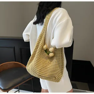 Detail of yellow woven tote bag showing hollow knit texture and summer tulip decoration