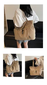 Macro view of khaki tote bag featuring drawstring side pockets and wide shoulder strap