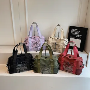 Large lightweight travel tote bags in five colors on display stand for sports or weekend trips