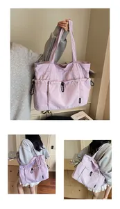 Detail of lavender tote bag featuring large pockets and wide shoulder straps for commuting