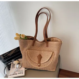 Close-up of natural woven straw texture with leather pocket and magnetic clasp detail
