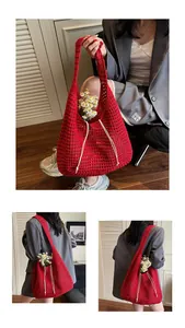 Detailed macro view of red hollow-out crochet knit tote bag with white drawstring