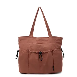 Caramel nylon tote bag with drawstring pockets for daily commute and casual use
