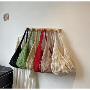 Detail view of colorful knitted hollow out beach tote bags in six different vibrant colors