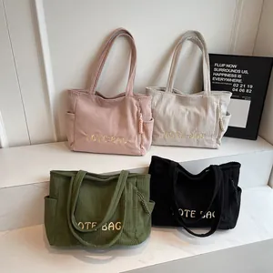 Minimalist corduroy tote bags in four colors with embroidered letters and long handles