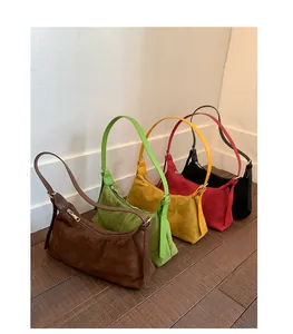 Detailed view of women's suede shoulder bags in five colors with zipper closure