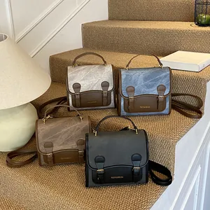 Vintage style square crossbody bag in four colors with handle and buckle details