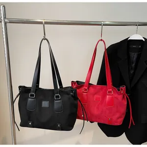 Detail view of large tote bags in matte texture with adjustable drawstring side accents