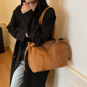 Brown large capacity suede tote bag with smooth leather handles for elegant daily commuting