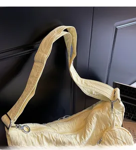 Close-up of wide strap and wrinkled fabric texture on yellow pleated tote bag