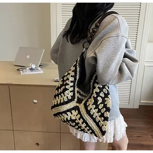 Detail of woven tote bag with wooden bead shoulder strap and geometric pattern