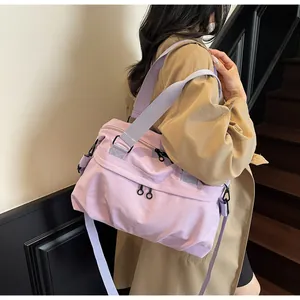 Close-up of light purple nylon messenger bag with wide shoulder strap and zippers