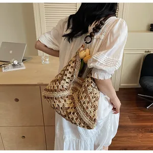 Detail of straw woven tote bag with wooden bead straps and tulip decorations inside