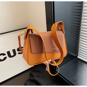 Detail of orange leather and brown woven texture on a fashion crossbody square bag