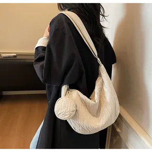 Detail of a beige pleated hobo bag with a matching detachable round coin purse