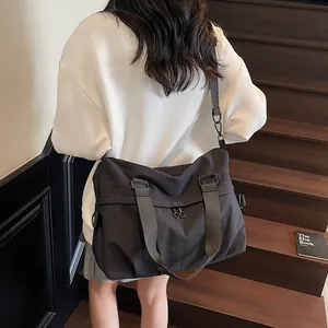 Large black nylon crossbody messenger bag for women with adjustable strap for daily commute