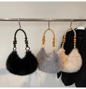 Detailed close-up of plush hobo bags with wooden bead handles in black, grey, and beige