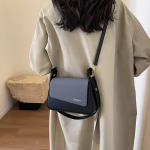 Minimalist vintage flap crossbody bag with gray fabric texture and gold hardware details