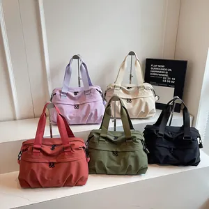 Large nylon travel bags set in five solid colors with dual handles and front zip pockets