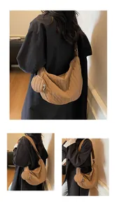 Detail of a brown quilted crescent bag with a matching round coin purse and soft pleats