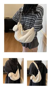 Detailed view of cream quilted crossbody bag with matching round coin purse attachment