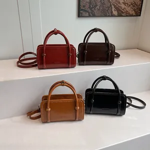 Minimalist square crossbody bags in four colors with polished leather finish and handles