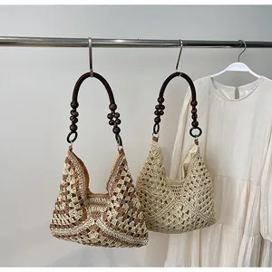 Detail view of woven crochet tote bags with decorative dark polished wooden bead handles
