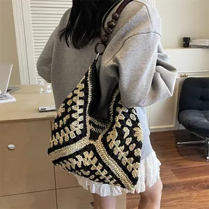Large woven tote bag with black and white geometric pattern and wooden bead strap