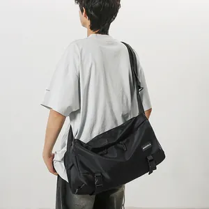 Large black nylon messenger bag with adjustable strap and buckle closure for daily commute